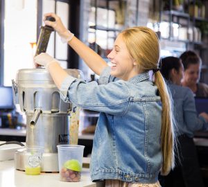 A Original ChopShop employee making Juice