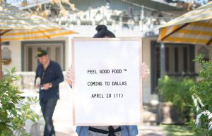 a woman holding a sign for Original ChopShop