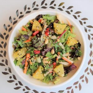 A Citrus Thai Salad artfully positioned on a table from Original ChopShop